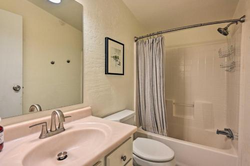 a bathroom with a sink and a toilet and a shower at Munds Park Cabin with Wraparound Deck and Grill! in Munds Park