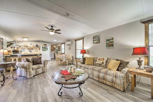a living room with two couches and a table at Bring a Pet Smoky Mtn Vacation Rental with Yard! in Whittier