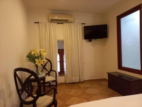 a room with two chairs and a projection screen at Marhialja Hotel Boutique in Oaxaca City