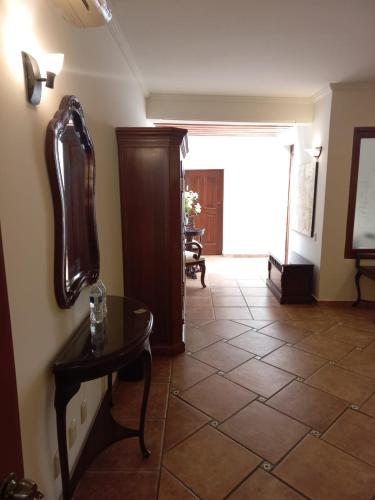 a living room with a table and a hallway at Marhialja Hotel Boutique in Oaxaca City