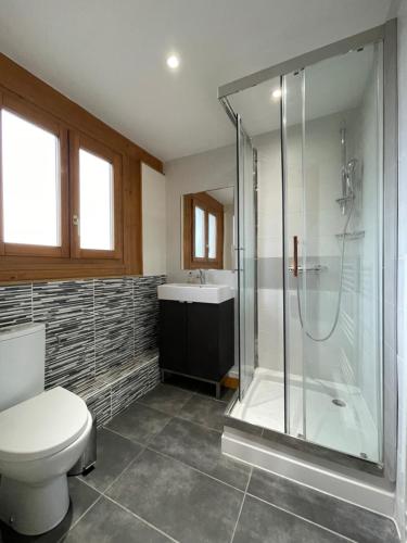 uma casa de banho com um chuveiro, um WC e um lavatório. em Chalet Chantelle em Morzine