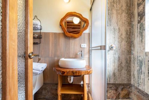 a bathroom with a sink and a shower at Unuwasi Hotel & Villa in Calca