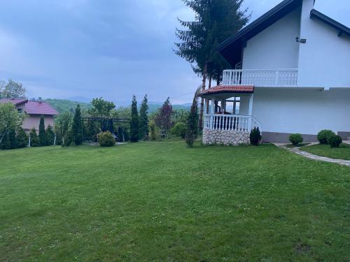 a house with a large yard with a grass field at Villa Gagula in Sarajevo