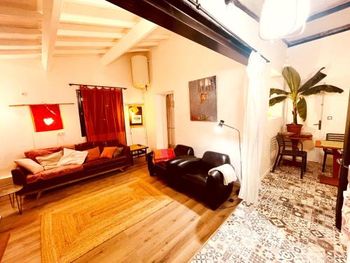 een woonkamer met een bank en een tafel bij Casa les bambous in Nîmes