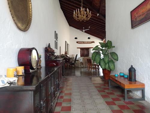 a hallway with a table and chairs in a room at Casa Yoly Hostel Granada in Granada