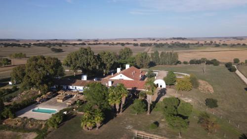 an aerial view of a house in a field at Lodge Monte Do Sobral in Alcáçovas