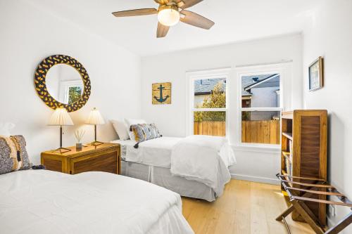 a bedroom with two beds and a window at Mid-Town Escape in Ventura