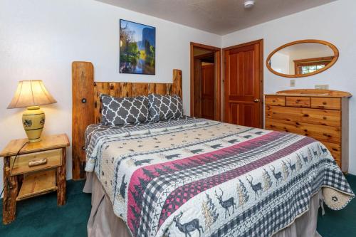 a bedroom with a bed and a dresser and a mirror at Scenic Wonders & Apt. in Yosemite West
