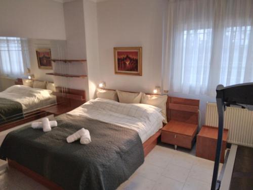 a bedroom with a bed with two white towels on it at Villa in Panorama, Thessaloniki, with a swimming pool. Host: Mr. George in Thessaloniki