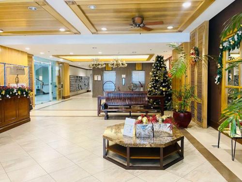 a lobby with a christmas tree and a couch at CedarPeak215 in Baguio