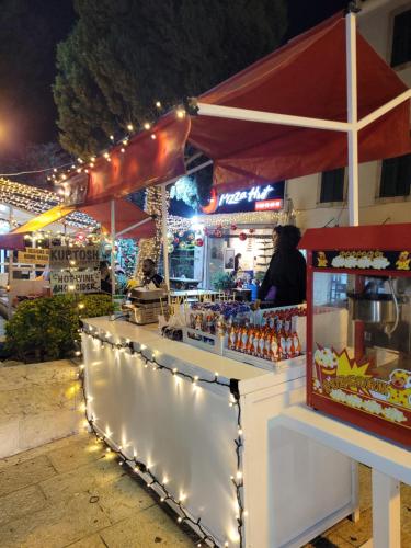 a bar with lights in front of a restaurant at Maya Guest House - German Colony & Baháí Gardens, Haifa in Haifa