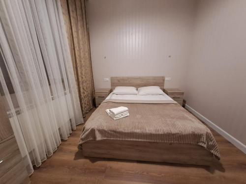 a bedroom with a bed with a towel on it at КВАРТИРА 124 in Yerevan