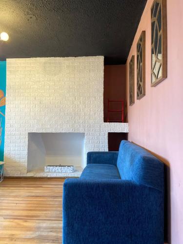 a blue couch in a living room with a fireplace at Blue house La Floresta in Quito