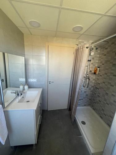 a bathroom with a sink and a shower and a tub at Apartamento Coman Av Rey Juan Carlos I in Torrent