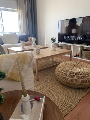 a living room with a couch and a tv at Apartamento Luxury Mira Espanha na Guarda in Guarda