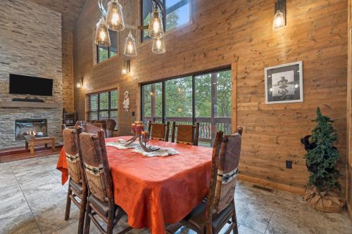a dining room with a table and a fireplace at Table Rock Resorts at Indian Point in Branson
