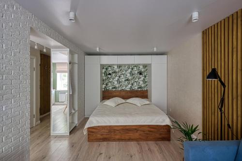 a bedroom with a bed and a painting on the wall at апартаменты Djent-house in Almaty