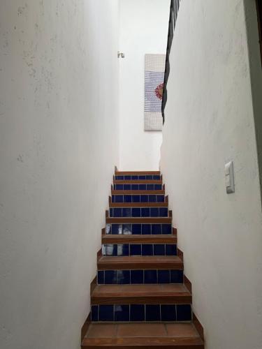 a stair case with blue tiles on the stairs at El Calvario Lofts in Antigua Guatemala
