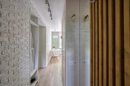 a bathroom with a walk in shower and a table at апартаменты Djent-house in Almaty