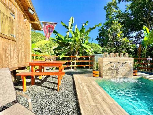 a backyard with a picnic table and a swimming pool at Cabaña Recordando El Ayer in San Lorenzo