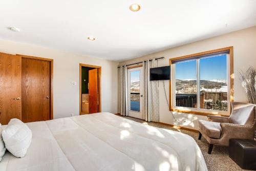 a bedroom with a large bed and a large window at Twenty Grand Chalet in Silverthorne