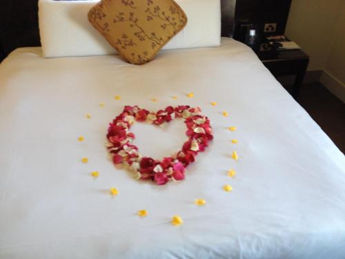 a heart made out of flowers on a bed at Bentota Home Stay in Bentota