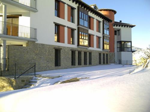 a building with snow in front of it at Coqueto apartamento en Valdelinares in Valdelinares