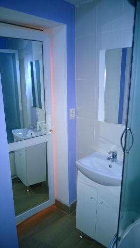 a bathroom with a sink and a mirror at M Central Apartments in Cluj-Napoca