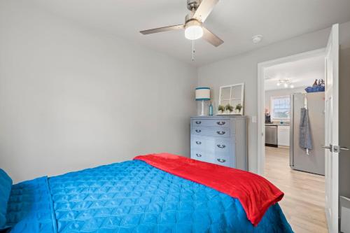 a bedroom with a blue bed and a ceiling fan at The Twisted Maple - Dogs Stay Free! in Hendersonville