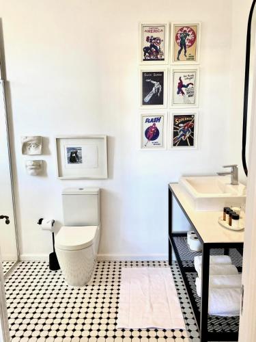 a bathroom with a white toilet and a sink at 1 Royal Street Guesthouse in Riebeek-Kasteel