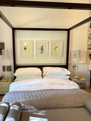 a bedroom with a large bed with two pillows at 1 Royal Street Guesthouse in Riebeek-Kasteel