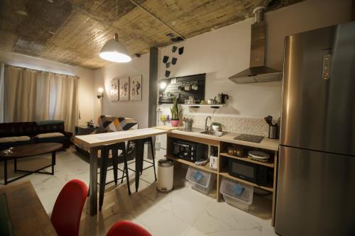 a kitchen with a refrigerator and a counter top at Casa suig in Baena