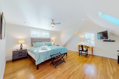a bedroom with a bed and a desk and a tv at Chic Spacious Home Half a Mile From Commercial Street in Provincetown