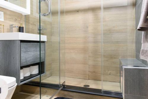 a bathroom with a shower with a glass door at 24-14 Renovated studio Prime gramercy W D in New York