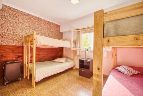 a bedroom with two bunk beds and a window at Hostel BILL & BILL in Mar del Plata