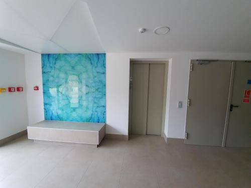 a white room with a blue painting on the wall at SDP Marina Apartment in Budapest