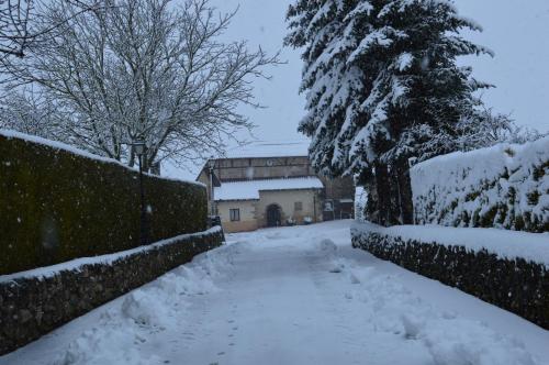 a driveway covered in snow in front of a house at Legaire Etxea in Ibarguren