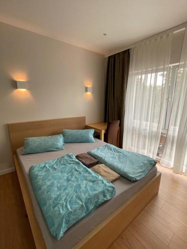 a bedroom with a large bed with blue pillows at Secret Studio Lux SPECIAL OFFER in Berlin