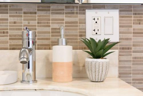 a bathroom sink with a faucet and a plant at 809-4A Columbus Circle New BLDG 1BR W D in New York