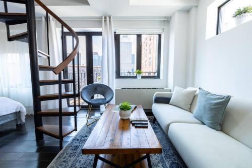 a living room with a white couch and a wooden table at 809-6B 2BR Duplex Breathtaking Views Beauty in New York