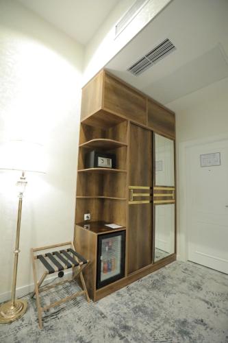 a living room with a fireplace in the corner at MaxWell Hotel & SPA in Tashkent