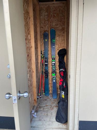 a group of skis and snowboards in a room at Tremblant Rocher Soleil Ski In Ski Out 2 Bedroom in Mont-Tremblant