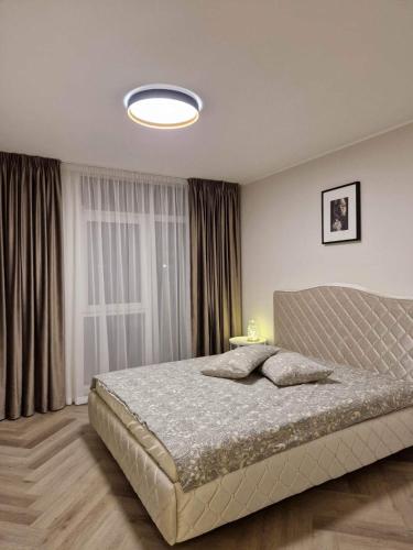 Katil atau katil-katil dalam bilik di Parko nauji apartamentai