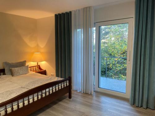 a bedroom with a bed and a large window at Auf der Alm 21 N.5 in Baden-Baden