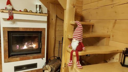 a log cabin with a fireplace and a christmas toy at Słoneczna Chata z Bali in Lądek-Zdrój