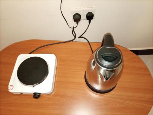 a blender and a speaker on a table at Pearl Furnished Rooms Buloba in Kampala