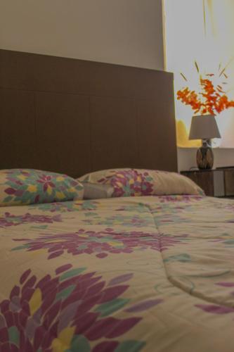 a bedroom with a large bed with a large headboard at Hotel y Café Ixmati Suchitoto in Suchitoto