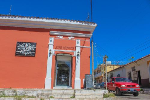 a red truck parked in front of a building at Hotel y Café Ixmati Suchitoto in Suchitoto