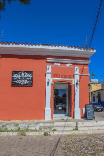 a orange building with a sign in front of it at Hotel y Café Ixmati Suchitoto in Suchitoto