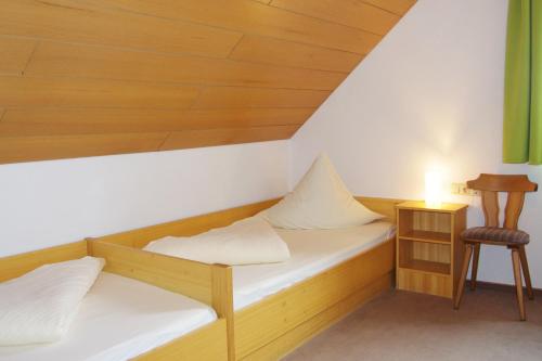 a room with two bunk beds and a chair at Löwenhof in Krumbach